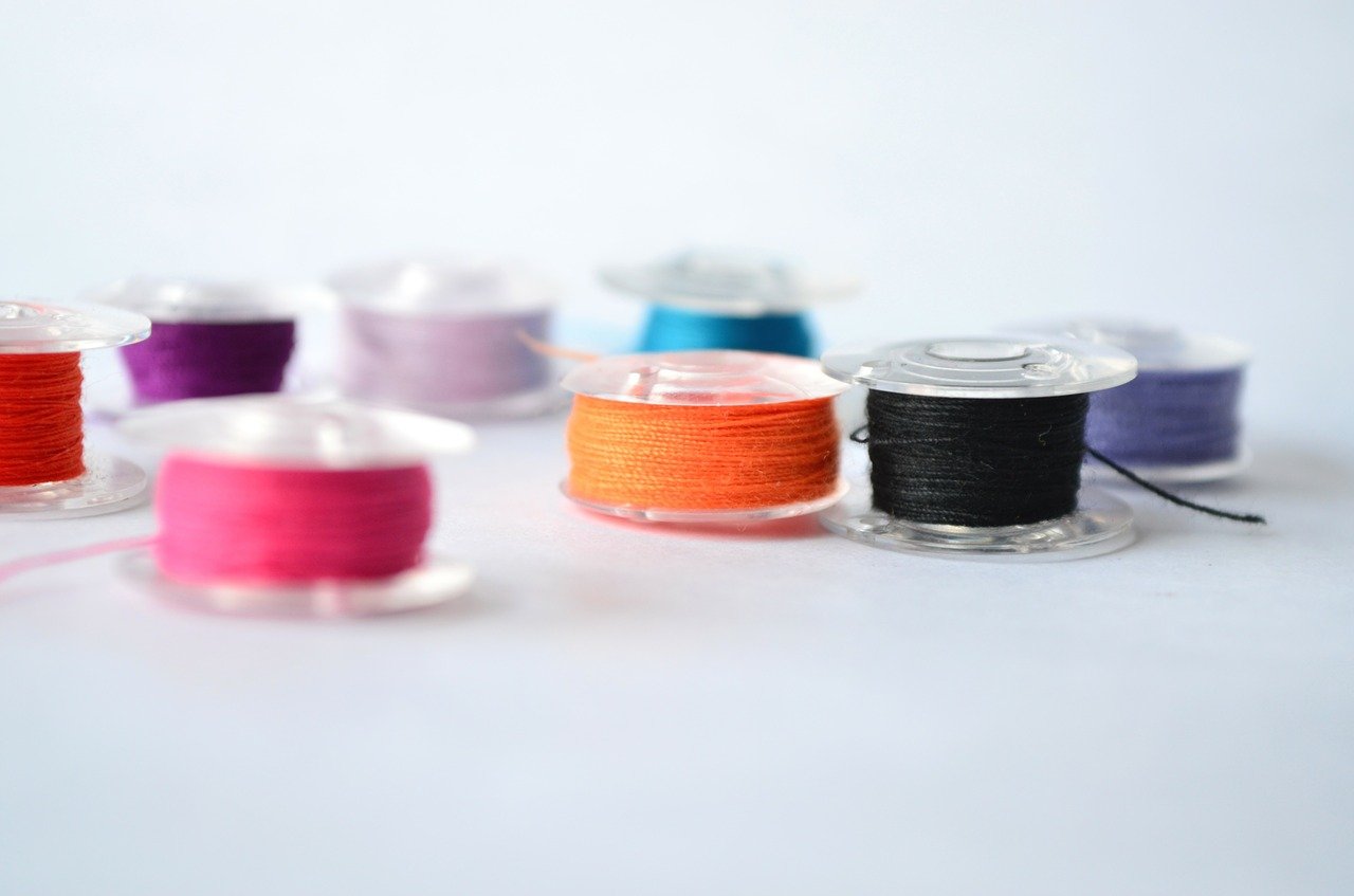 bobbin with threads isolated on table surface