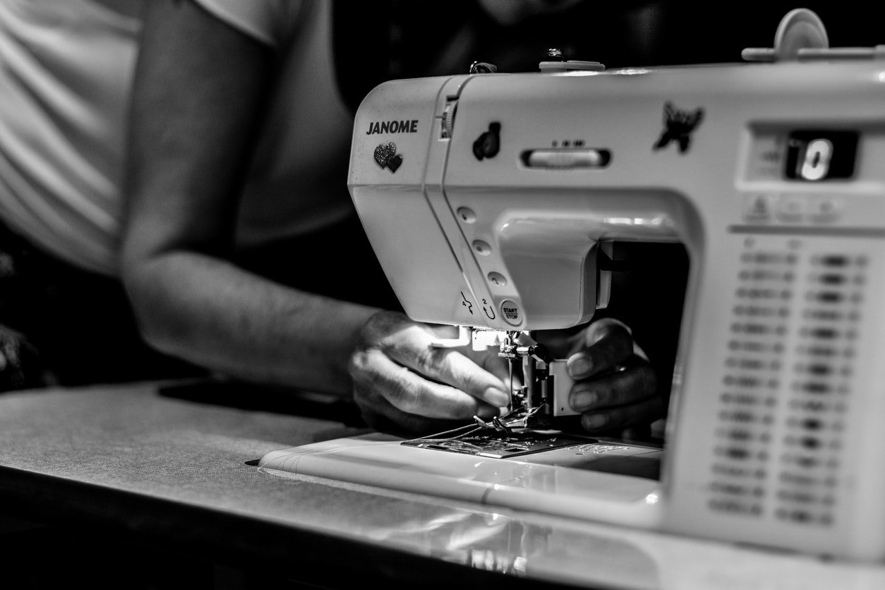 person checking his sewing machine