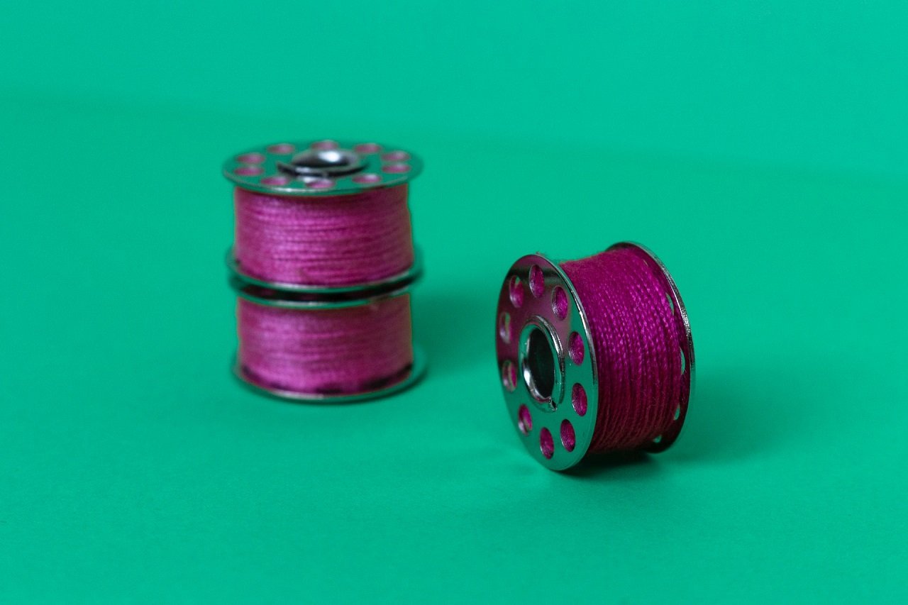 sewing machine bobbin filled with thread