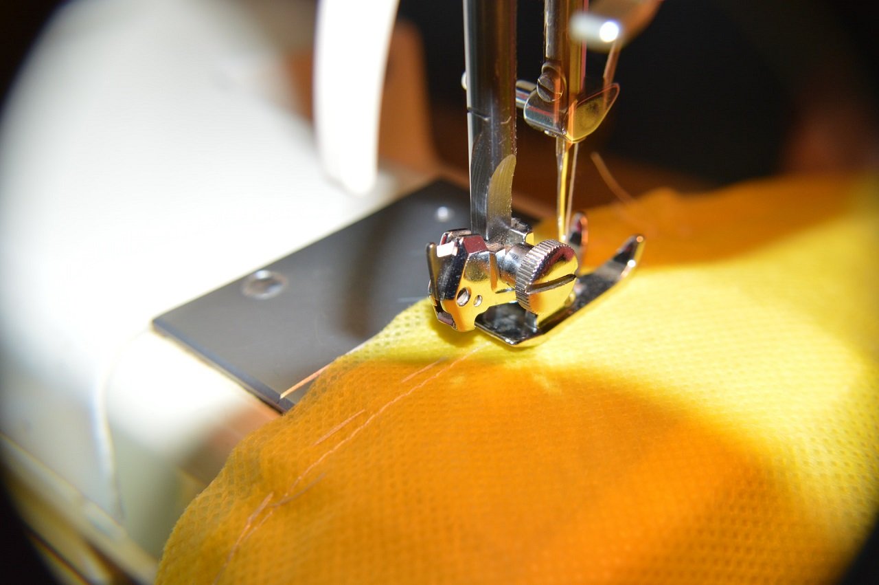 sewing machine stitches on yellow cloth